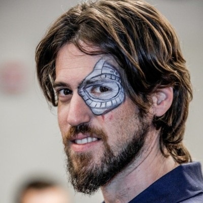 Home Omri Avny, smiling, with a game-themed face painting around one eye